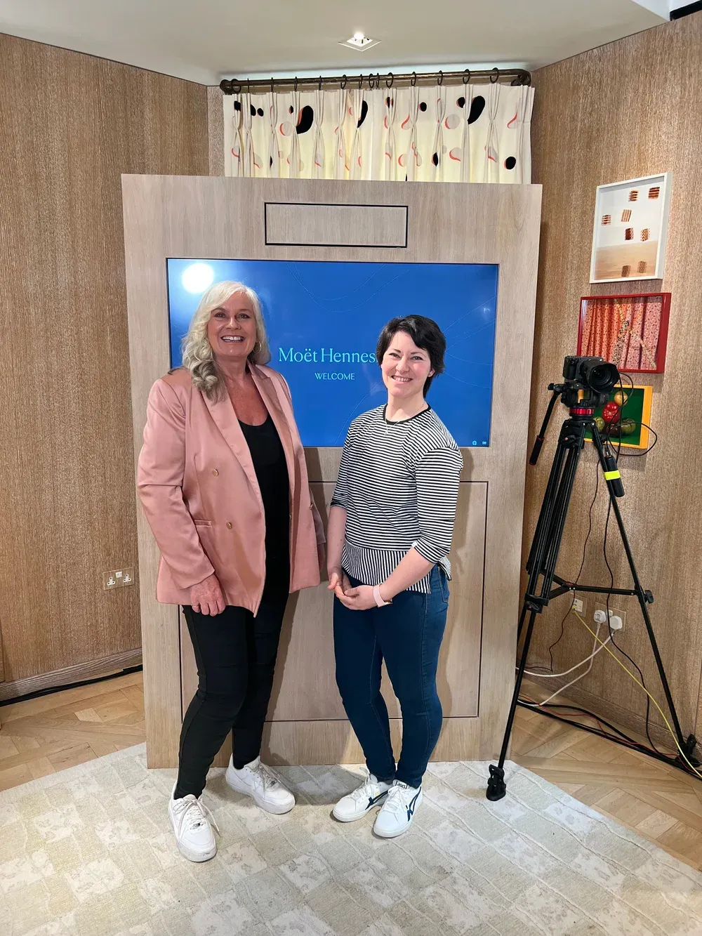 Alison with the event organiser beside the Moët Hennessy welcome screen at the Louis Vuitton apartments.