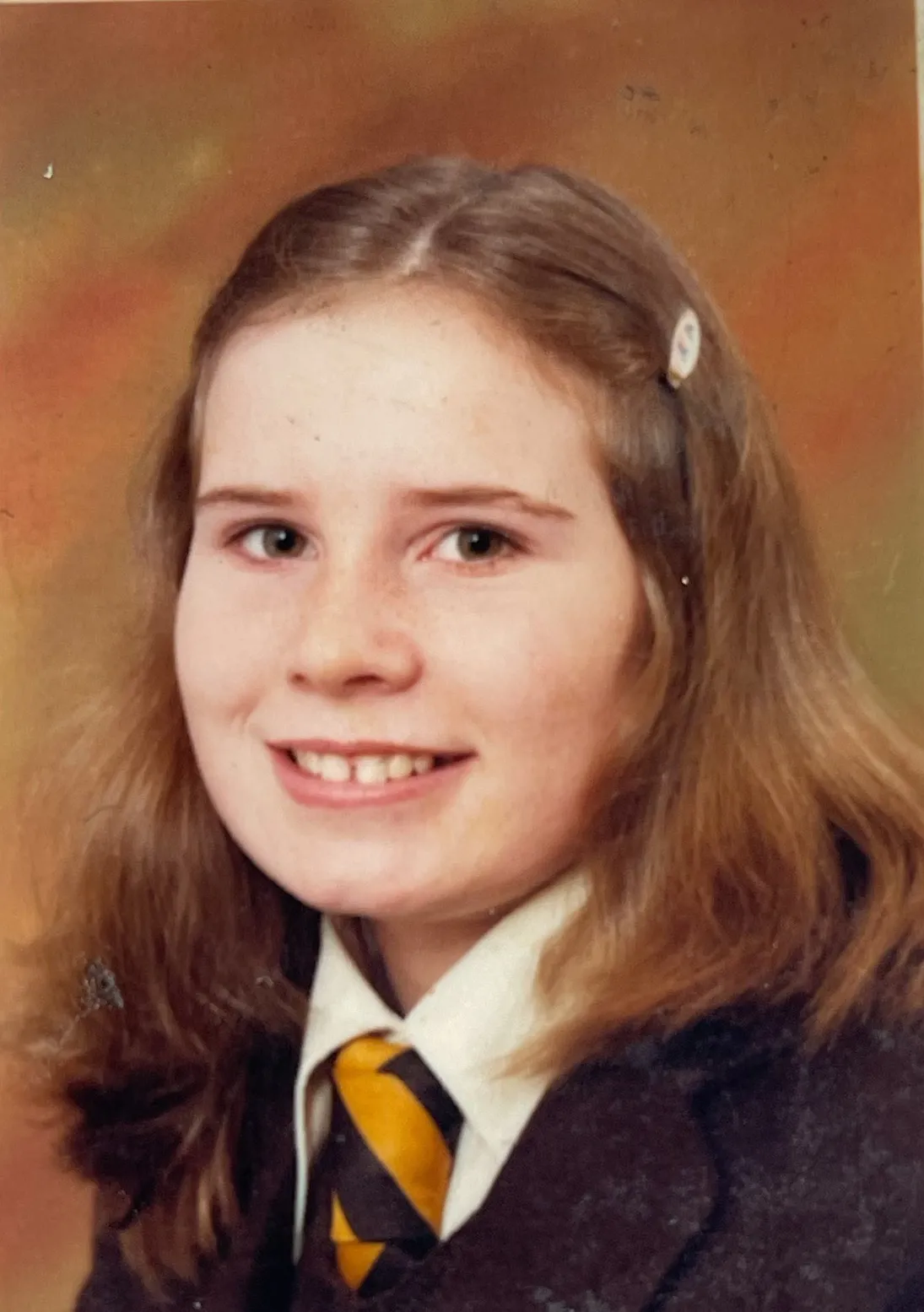 Alison’s school photo: smiling in her uniform and striped tie.