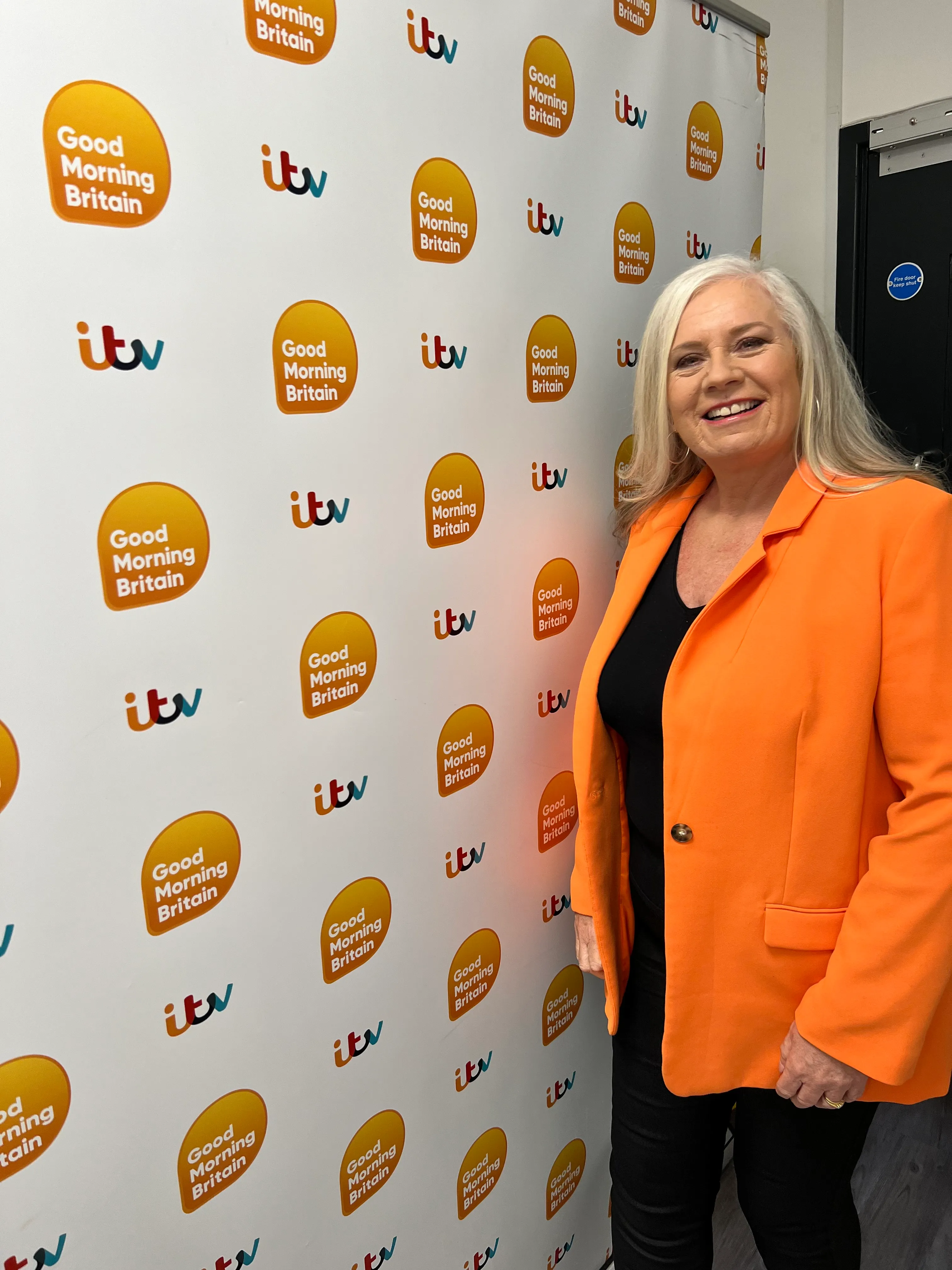 Alison in front of the Good Morning Britain press wall at the ITV studios.