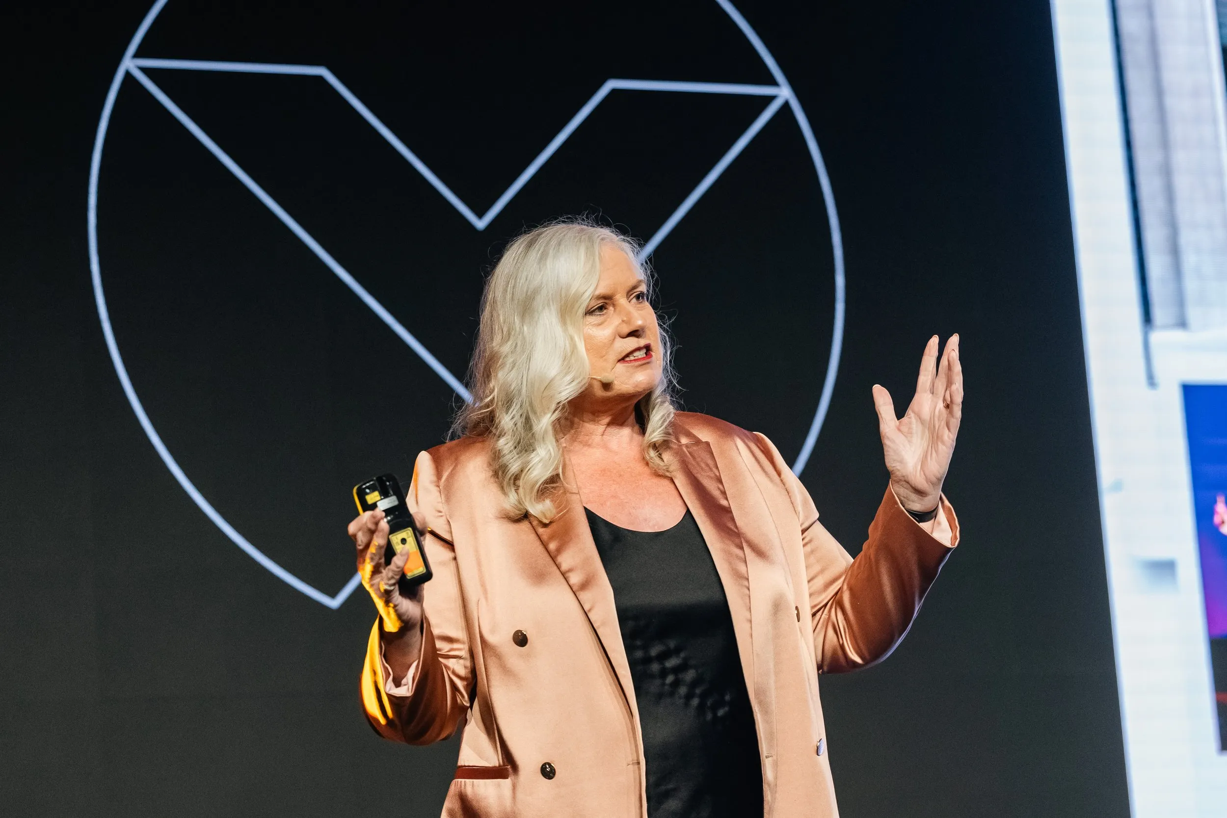 Dr Alison Edgar MBE delivering a keynote on stage.
